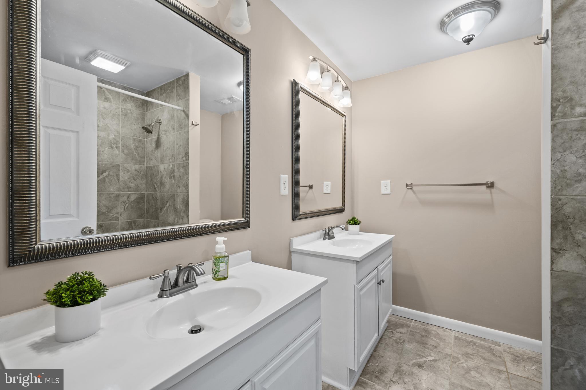 20350 Colton Point Road Coltons Point, MD 20626 - Photo 23 of 30 a bathroom with a double vanity sink mirror and double