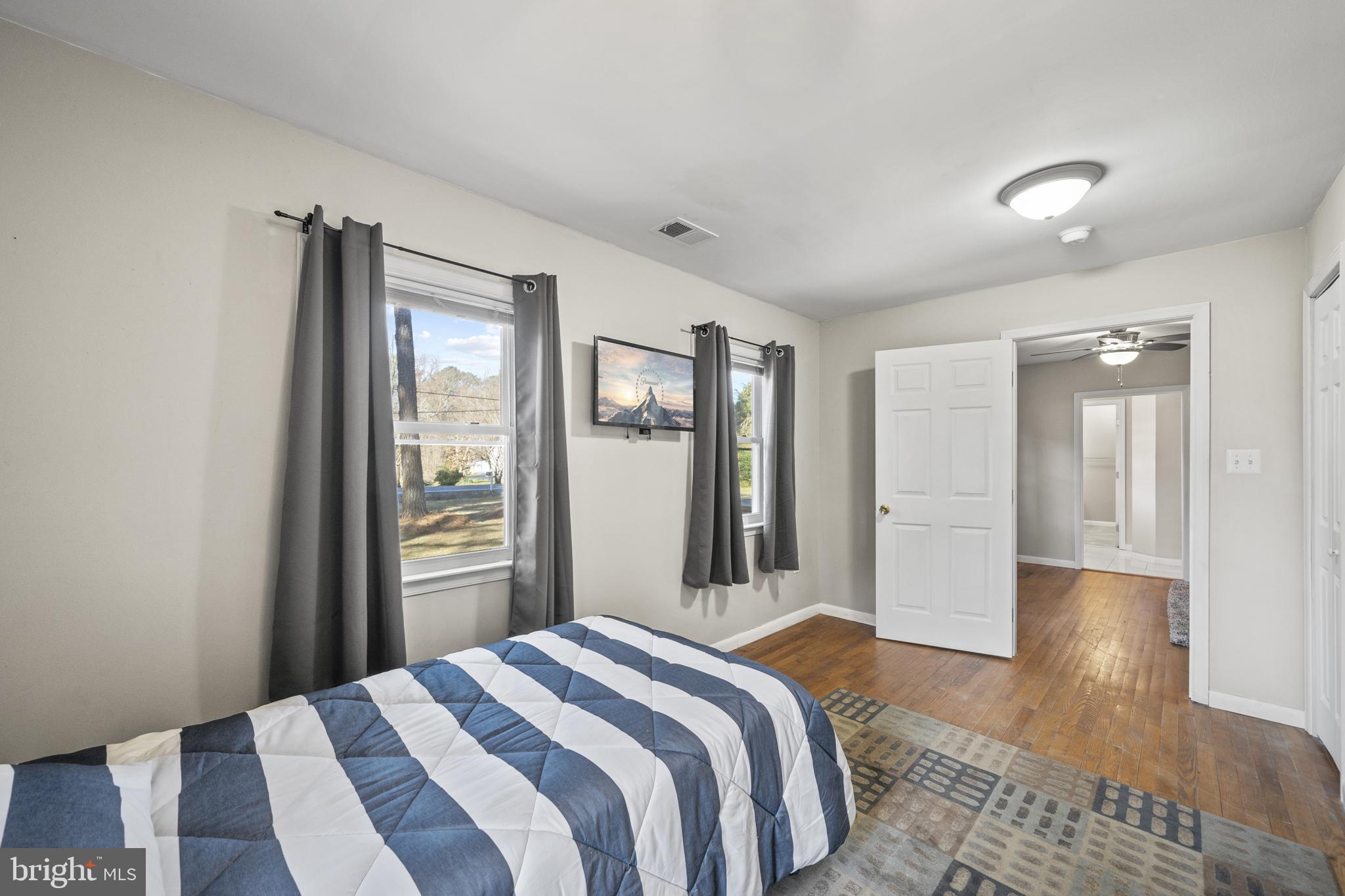 20350 Colton Point Road Coltons Point, MD 20626 - Photo 29 of 30 a bedroom with a bed and wooden floor