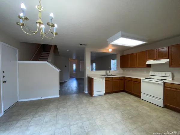 a kitchen with stainless steel appliances granite countertop a stove and a refrigerator
