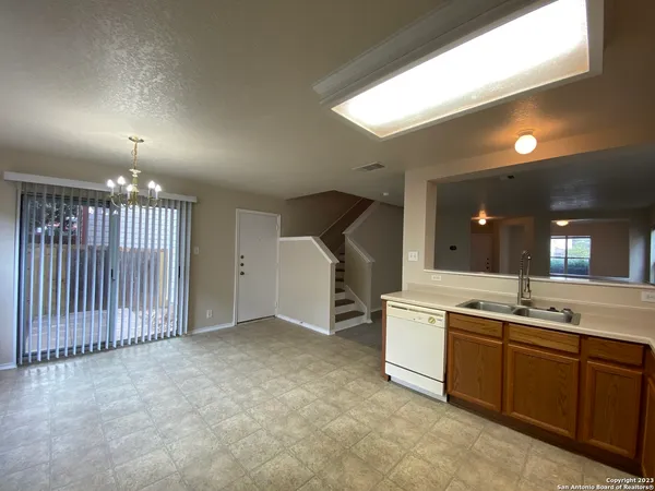 a view of a kitchen with a sink and dishwasher oven