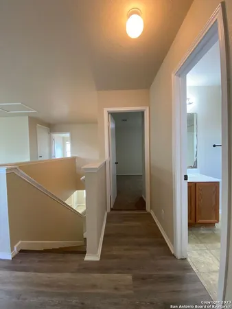 a view of a hallway with wooden floor