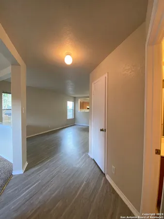 a view of a hallway with wooden floor