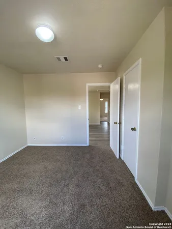 a view of a room with a ceiling fan and a window