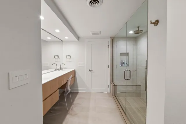 a bathroom with a shower sink and mirror