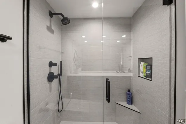 a bathroom with a shower and a sink