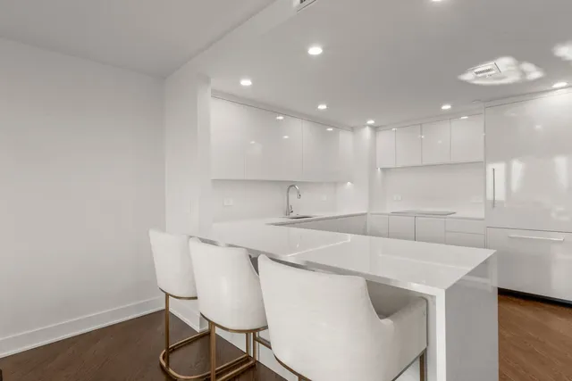 a kitchen with a sink cabinets and wooden floor