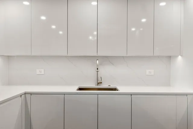 a kitchen with a sink and cabinets