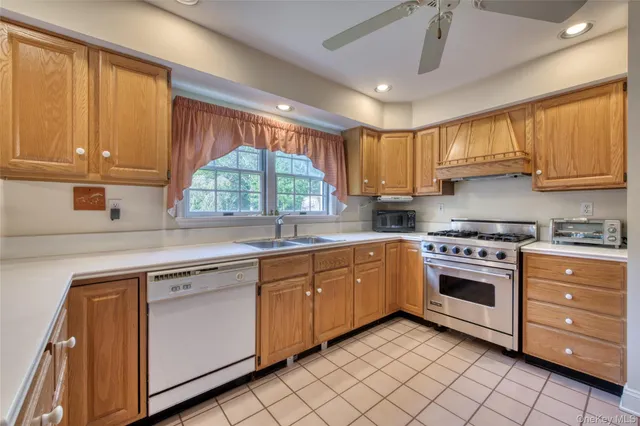 a kitchen with a stove sink and cabinets