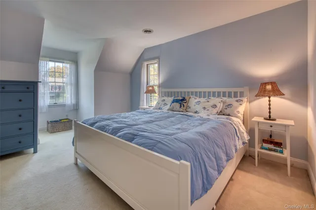 a spacious bedroom with a bed and a window