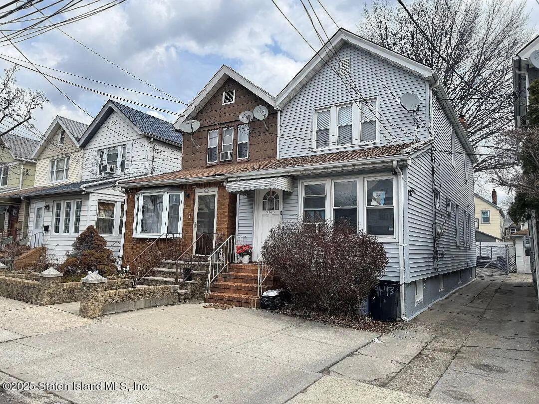 a front view of a house with yard and glass windows