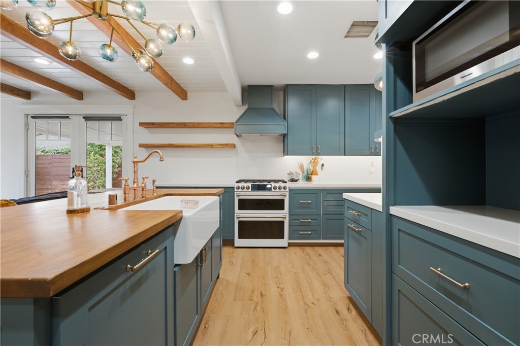5559 East Monlaco Road Long Beach, CA 90808 - Photo 14 of 54 Custom Lighting and a GE Cafe Range/Stove
