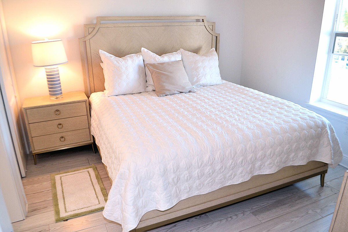 1740 South Co Highway 393, Unit #312 Santa Rosa Beach, FL 32459 - Photo 13 of 36 a large bed sitting in a bedroom next to a window