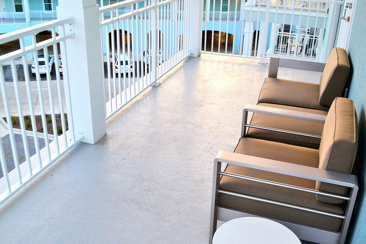 1740 South Co Highway 393, Unit #312 Santa Rosa Beach, FL 32459 - Photo 16 of 36 a view of a porch with wooden floor and fence