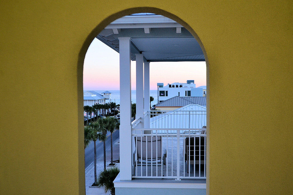 1740 South Co Highway 393, Unit #312 Santa Rosa Beach, FL 32459 - Photo 6 of 36 a view of a balcony with furniture and a floor to ceiling window