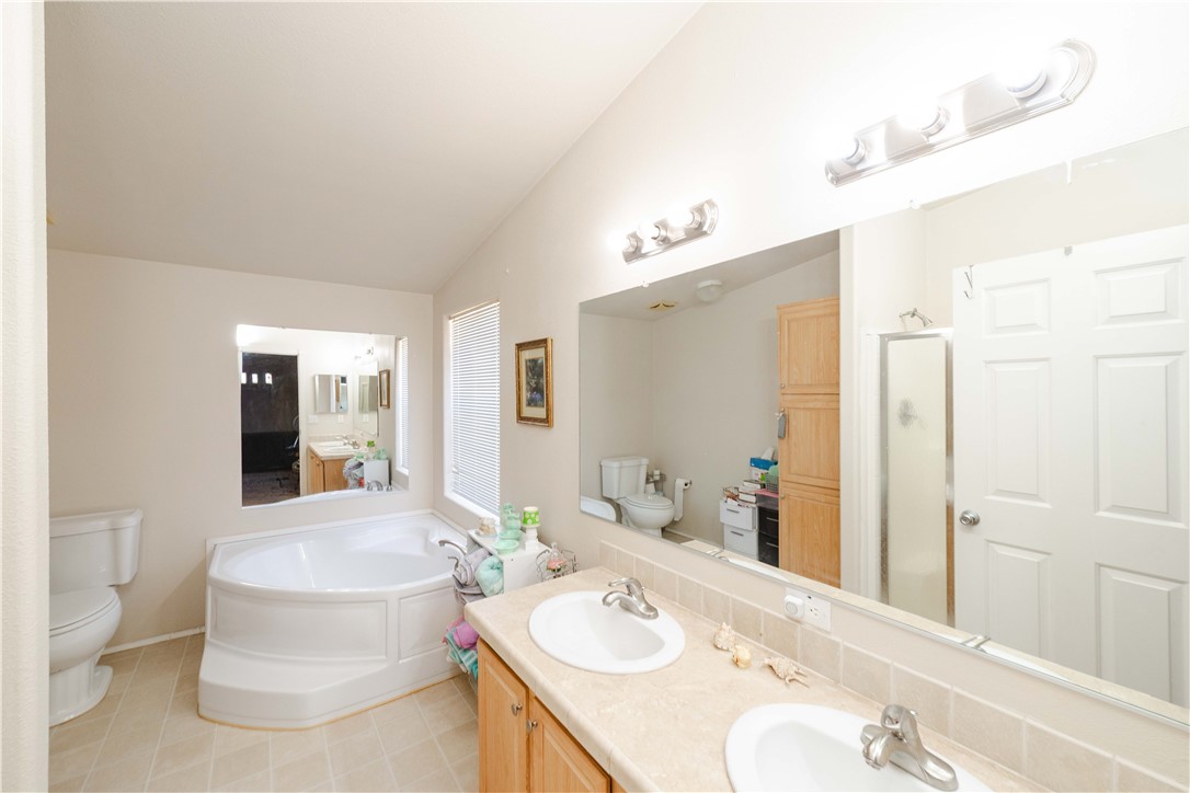4729 Stewart Mountain Road Golden Valley, AZ 86413 - Photo 13 of 28 a bathroom with a granite countertop sink and a mirror