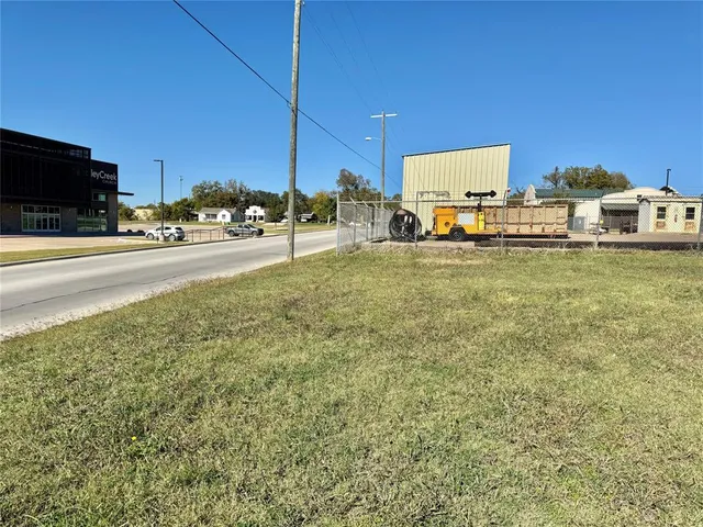 a view of a street with cars parked