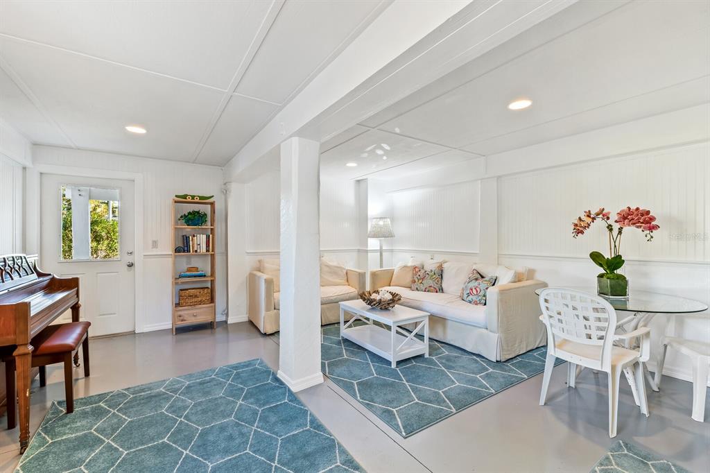 801 South Harbor Drive Boca Grande, FL 33921 - Photo 17 of 43 a living room with furniture a chandelier and a dining table