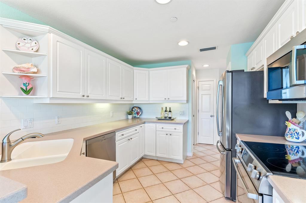 801 South Harbor Drive Boca Grande, FL 33921 - Photo 7 of 43 a kitchen with granite countertop a sink stainless steel appliances and cabinets