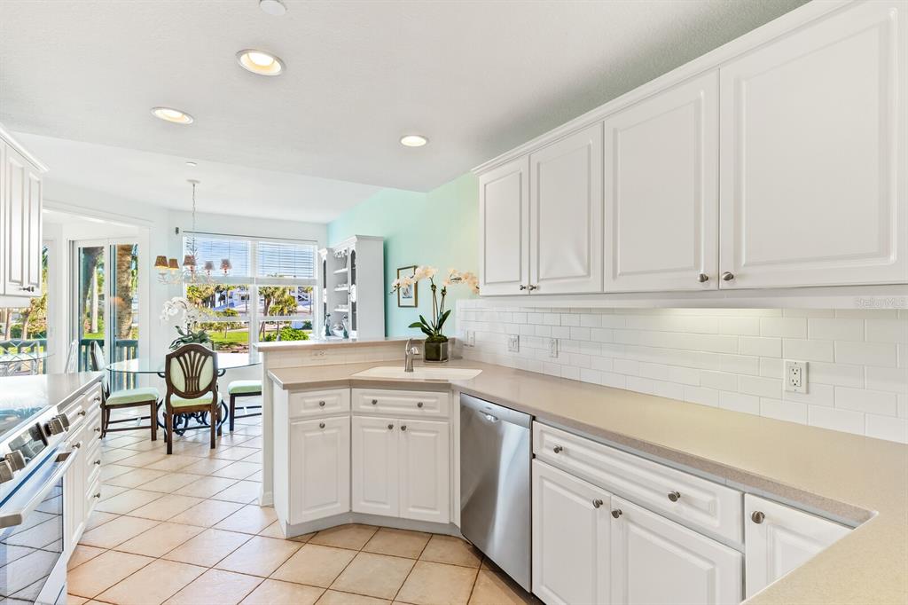 801 South Harbor Drive Boca Grande, FL 33921 - Photo 8 of 43 a kitchen with white cabinets and sink
