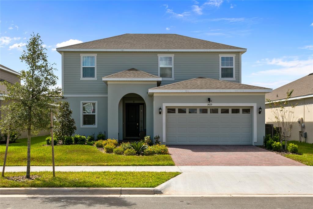 1429 Rosedale Road Davenport, FL 33837 - Photo 1 of 1 a front view of a house with a garden