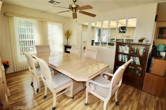 a view of a dining room with furniture window and wooden floor