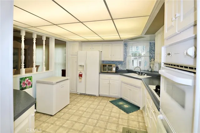 a kitchen with a sink and white cabinets
