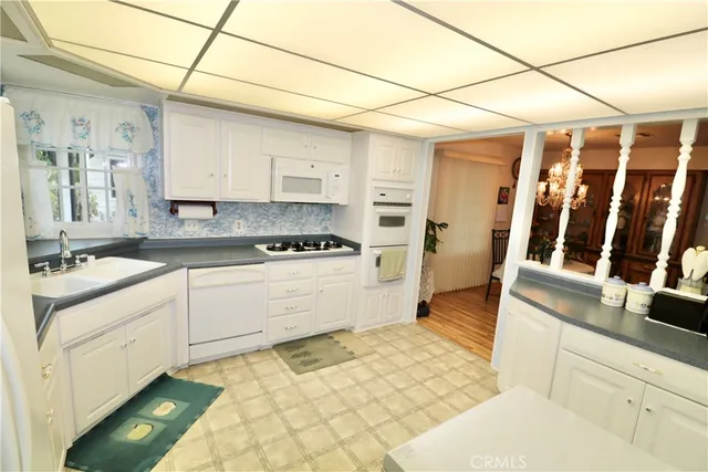 a kitchen with a stove a sink and a refrigerator