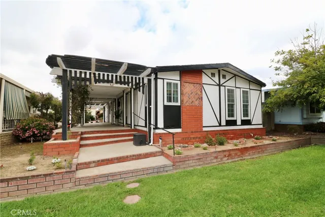 a view of a house with backyard porch and sitting area
