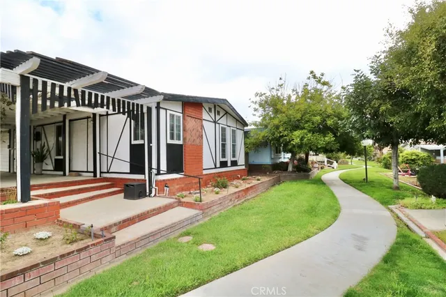 a view of a house with backyard and sitting area