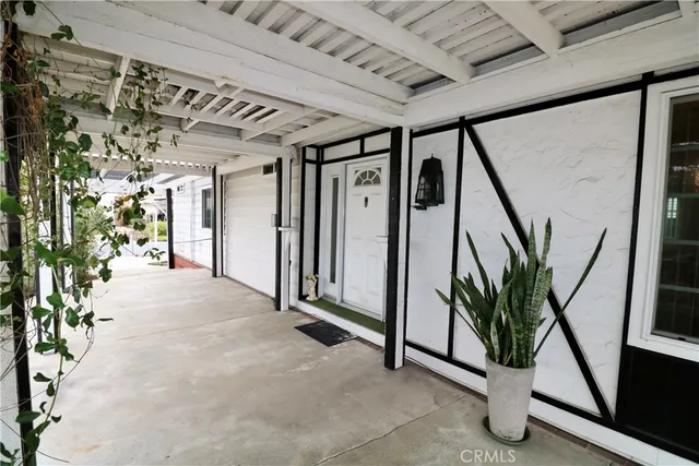 a view of a hallway with wooden floor and stairs