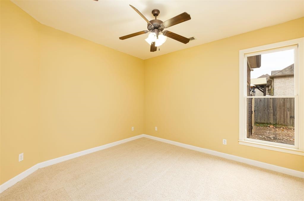 5380 Scarlet Ridge Drive Arlington, TN 38002 - Photo 19 of 35 Spacious room featuring neutral carpeting, light-toned walls, a ceiling fan with integrated lighting, and a double-hung window