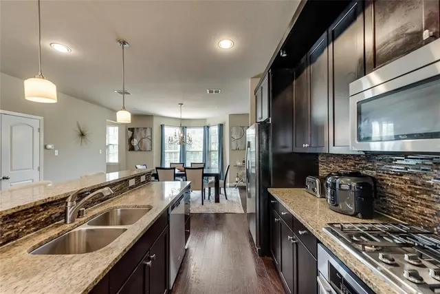 a kitchen with counter top space and stainless steel appliances