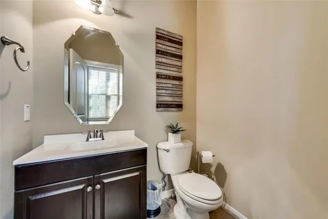 a bathroom with a sink a toilet and mirror