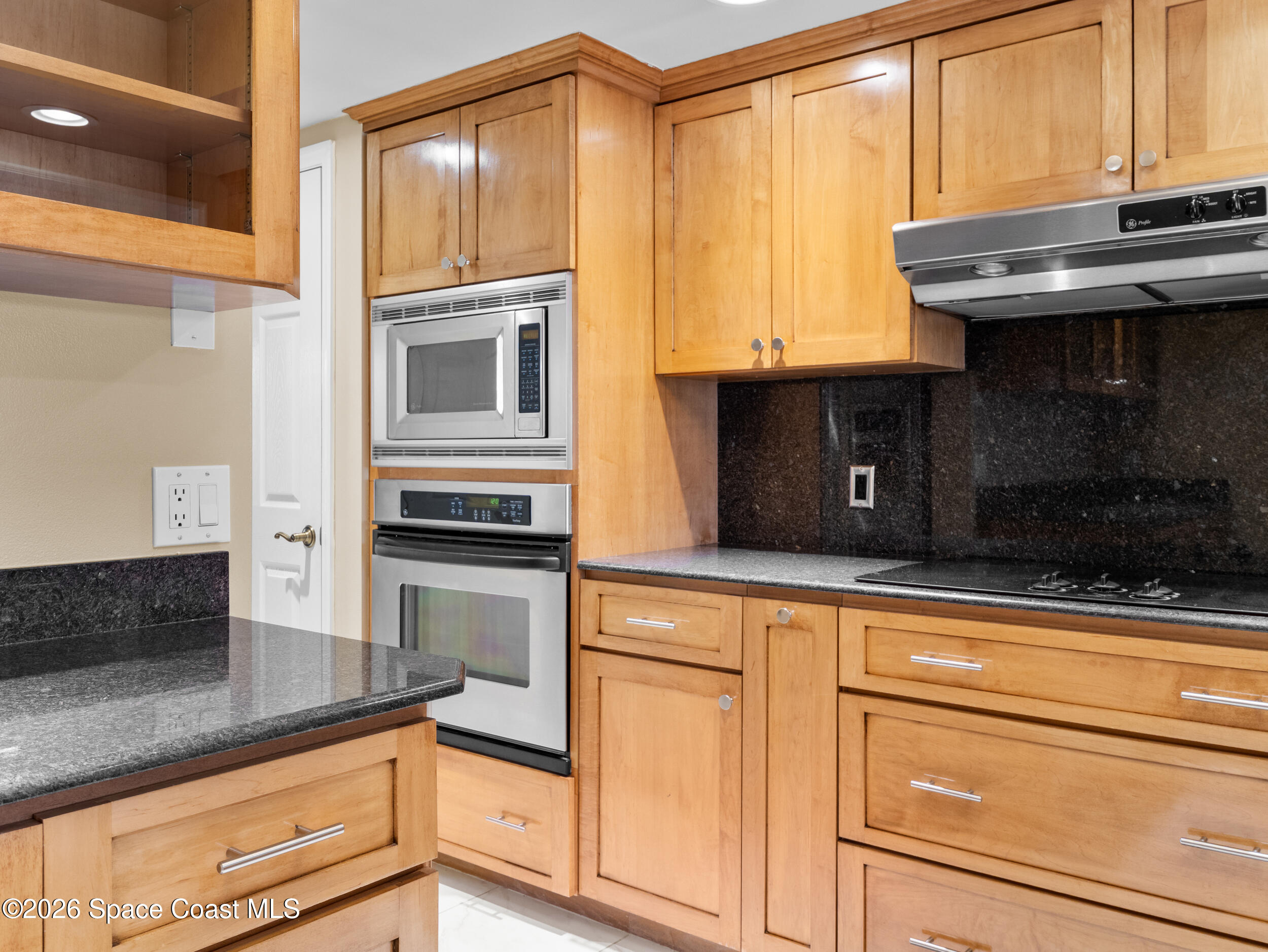2220 Front Street, Unit 303 Melbourne, FL 32901 - Photo 17 of 42 a kitchen with granite countertop cabinets stainless steel appliances and a counter space