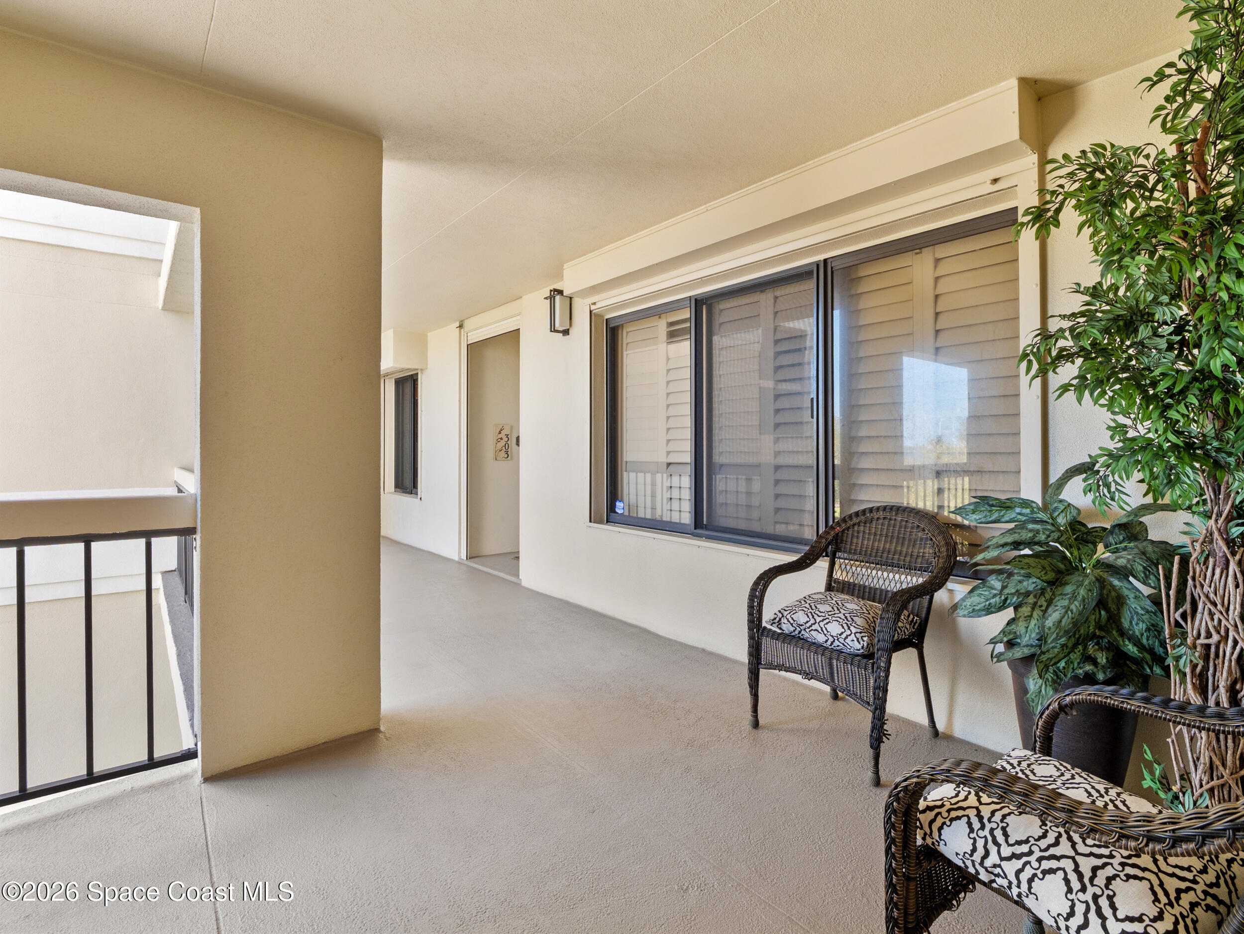 2220 Front Street, Unit 303 Melbourne, FL 32901 - Photo 31 of 42 a living room with furniture and a potted plant