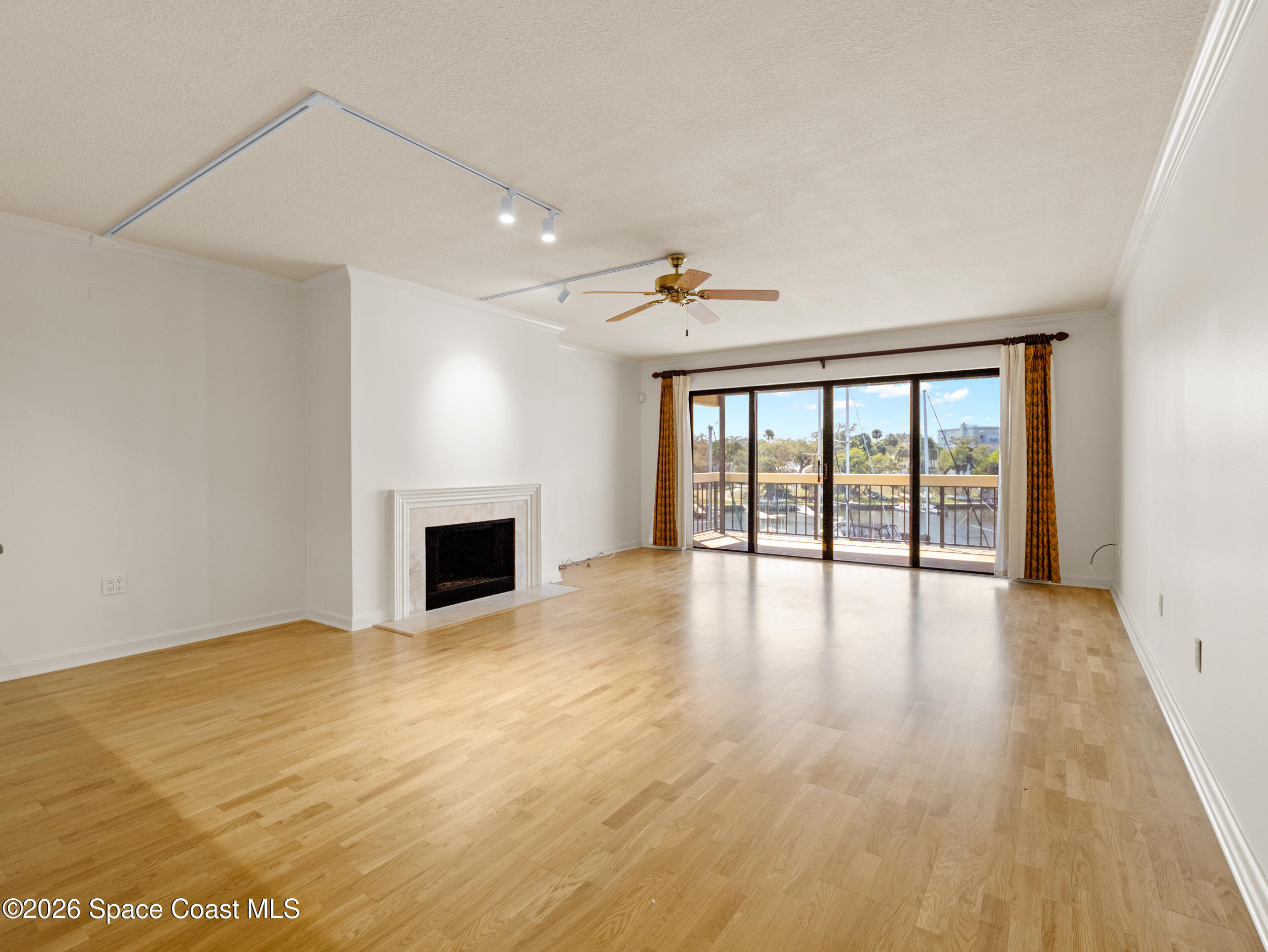 2220 Front Street, Unit 303 Melbourne, FL 32901 - Photo 5 of 42 a view of an empty room with wooden floor and a window