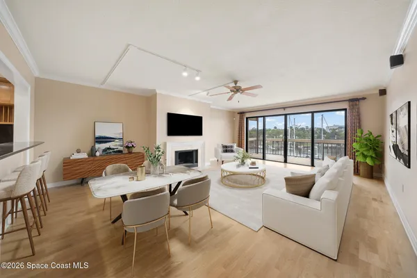 an empty room with chandelier fan and windows