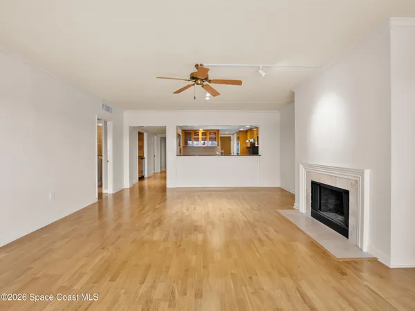 a spacious bedroom with a large bed and a flat tv screen on dresser