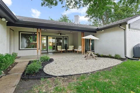 a view of a house with a small porch and furniture