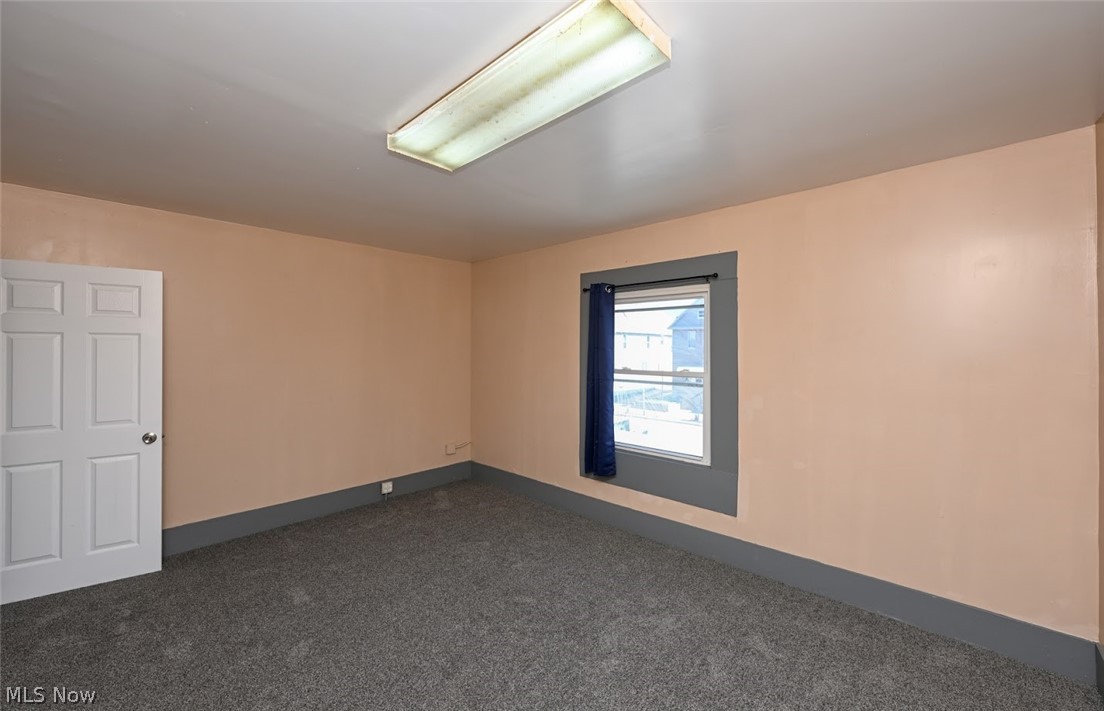 868 North Main Street Akron, OH 44310 - Photo 16 of 30 Empty room with dark colored carpet and baseboards