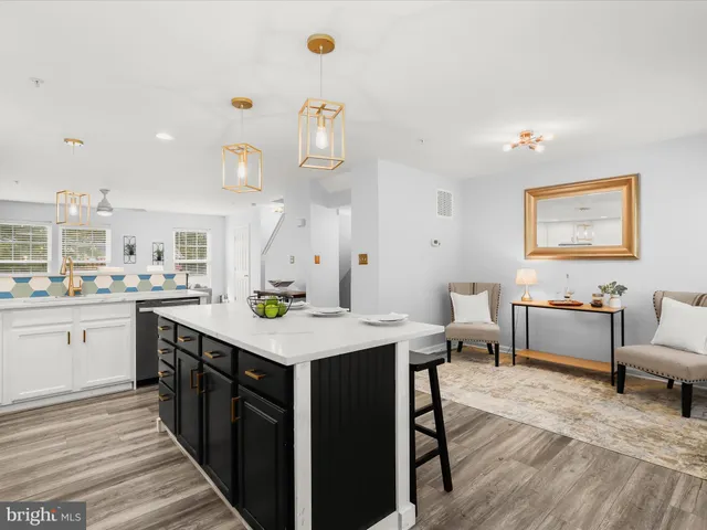 a kitchen with kitchen island a sink table and chairs