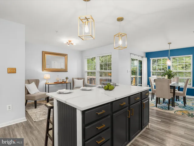 a view of a kitchen wooden cabinets and living room