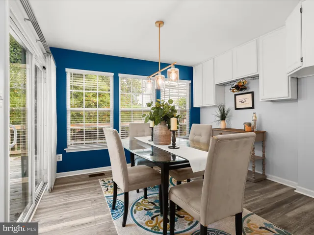 a dining room with furniture window and wooden floor
