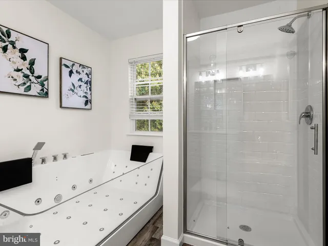 a bathroom with a bathtub and shower