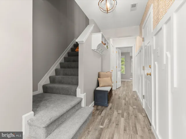 a view of entryway and hall with wooden floor