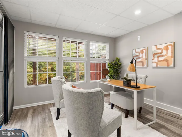 a dining room with furniture and window