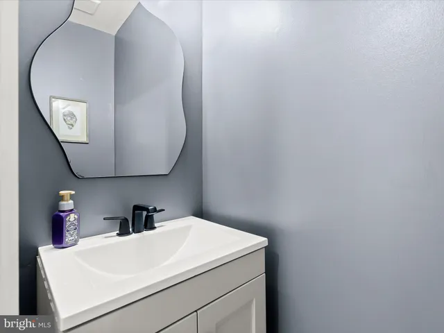a bathroom with a sink and mirror