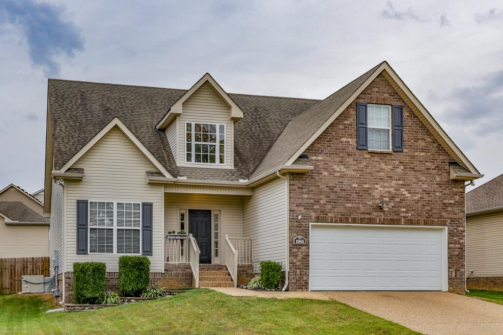 1045 Golf View Way Spring Hill, TN 37174 - Photo 1 of 26 a front view of a house with a yard and garage