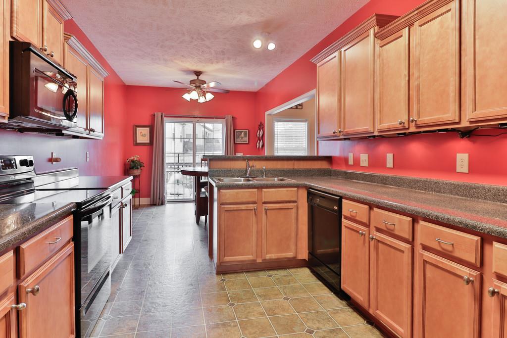 1045 Golf View Way Spring Hill, TN 37174 - Photo 11 of 26 a kitchen with stainless steel appliances granite countertop a sink stove and cabinets