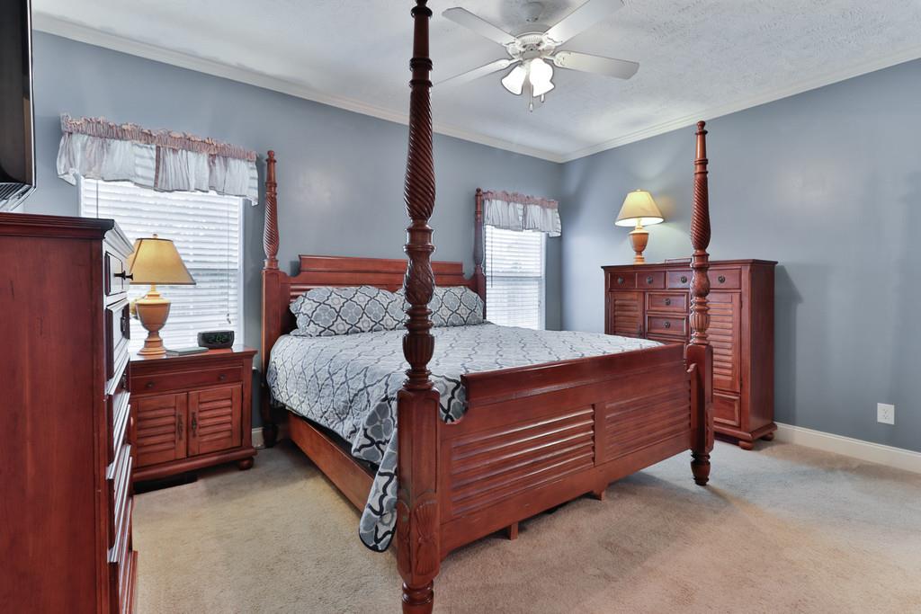 1045 Golf View Way Spring Hill, TN 37174 - Photo 15 of 26 a bed room with a bed and a chandelier